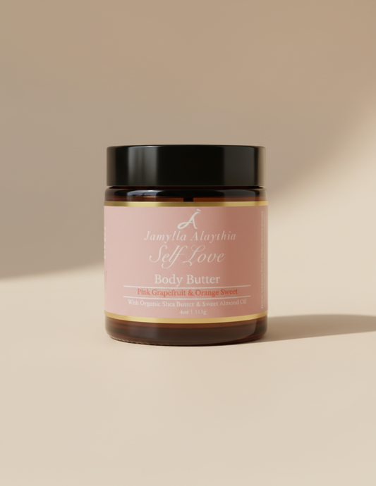 Jar of self love whipped body butter with a pink label &black lid on a beige background