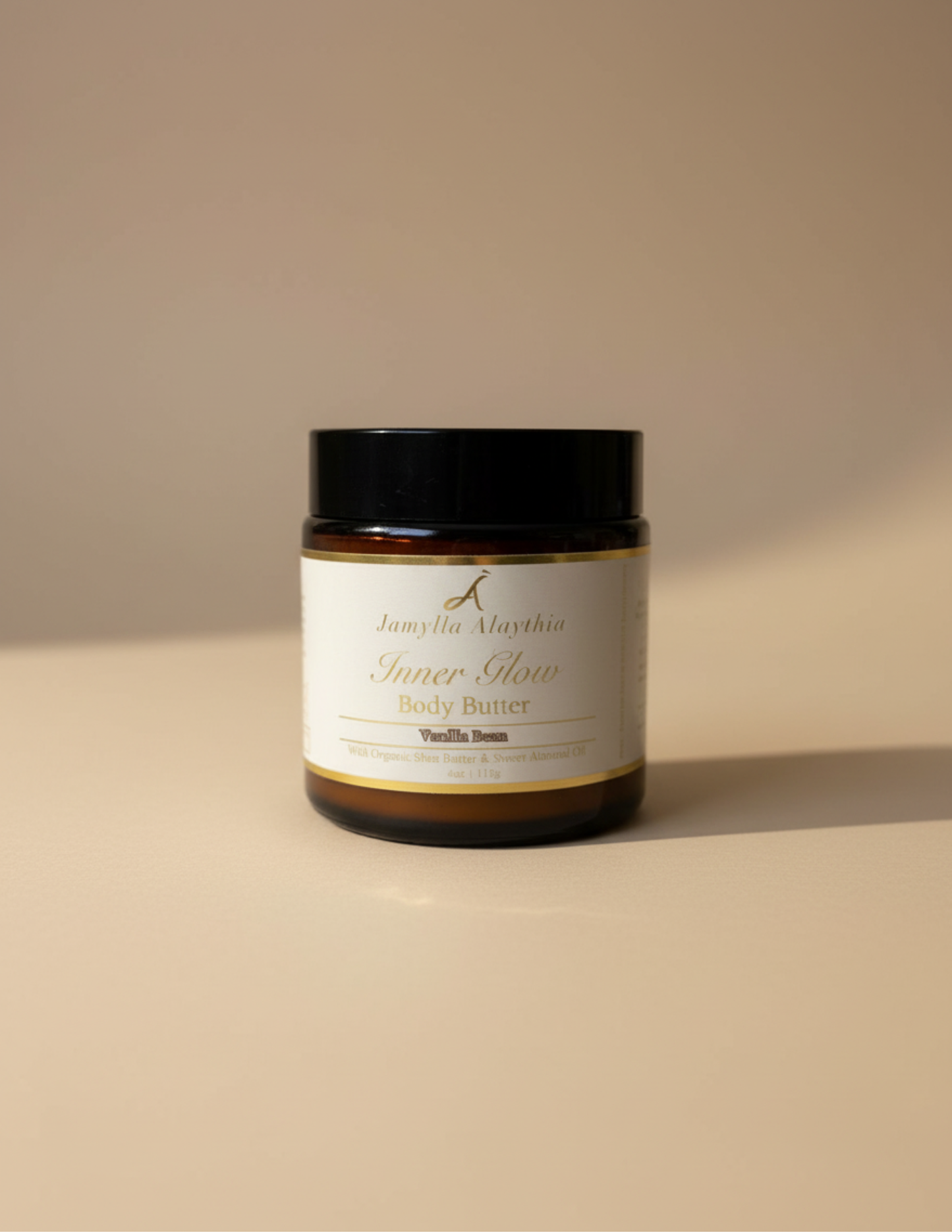 Jar of body butter, amber jar, black lid, with a label on a beige background