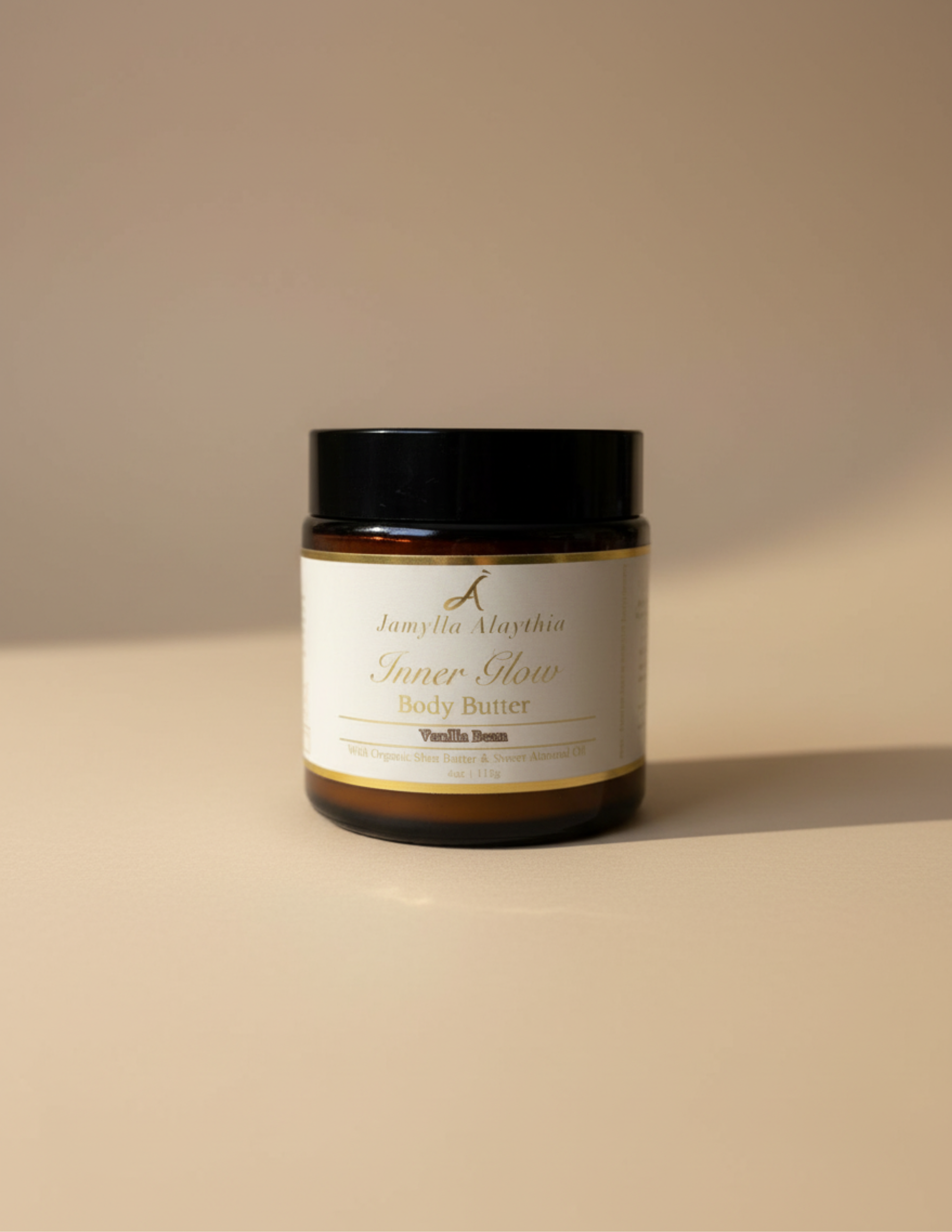 Jar of body butter, amber jar, black lid, with a label on a beige background