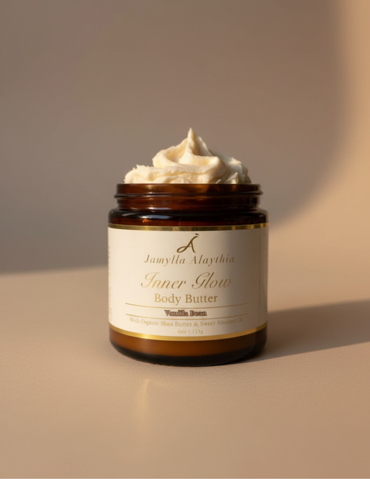 Jar of whipped vanilla body butter with a label on a beige background