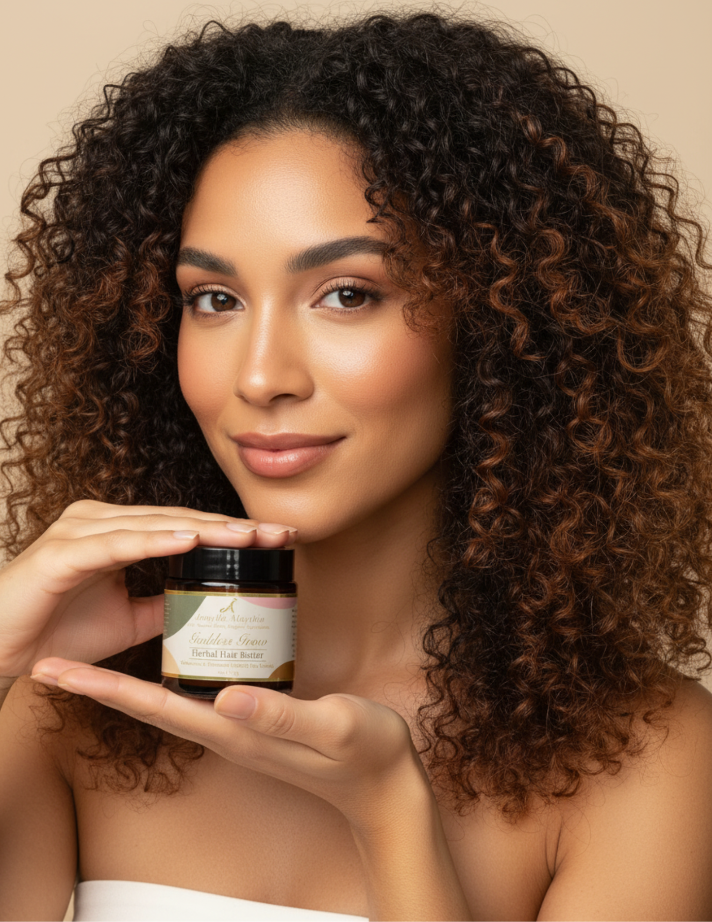 A black woman holding a jar of herbal hair butter with a neutral background