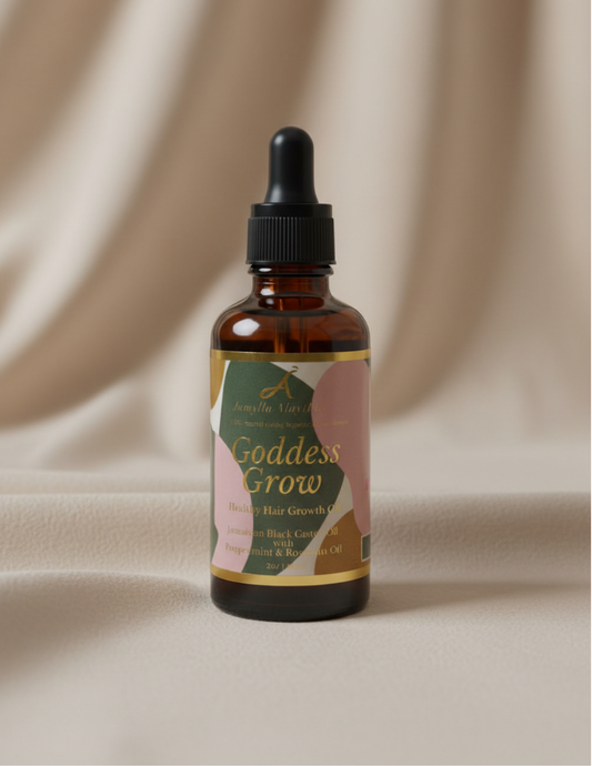 Bottle of 'Goddess Grow' hair growth oil on a beige fabric background
