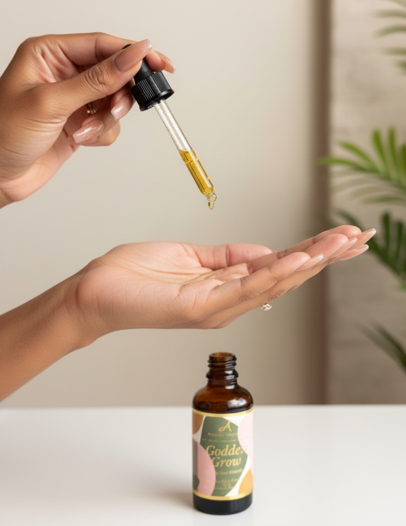 Hand holding a dropper with a small amount of liquid above a bottle labeled 'Goddess Herbs' on a light surface.